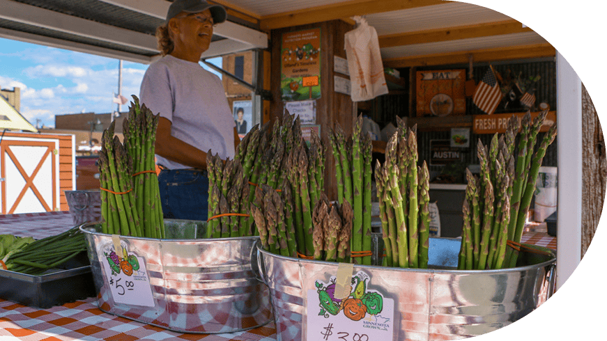 Asparagus in buckets at the farmers market.